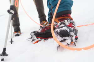 Descent from the Bishorn summit, man with crampon Descent from the Bishorn summit, man with crampon